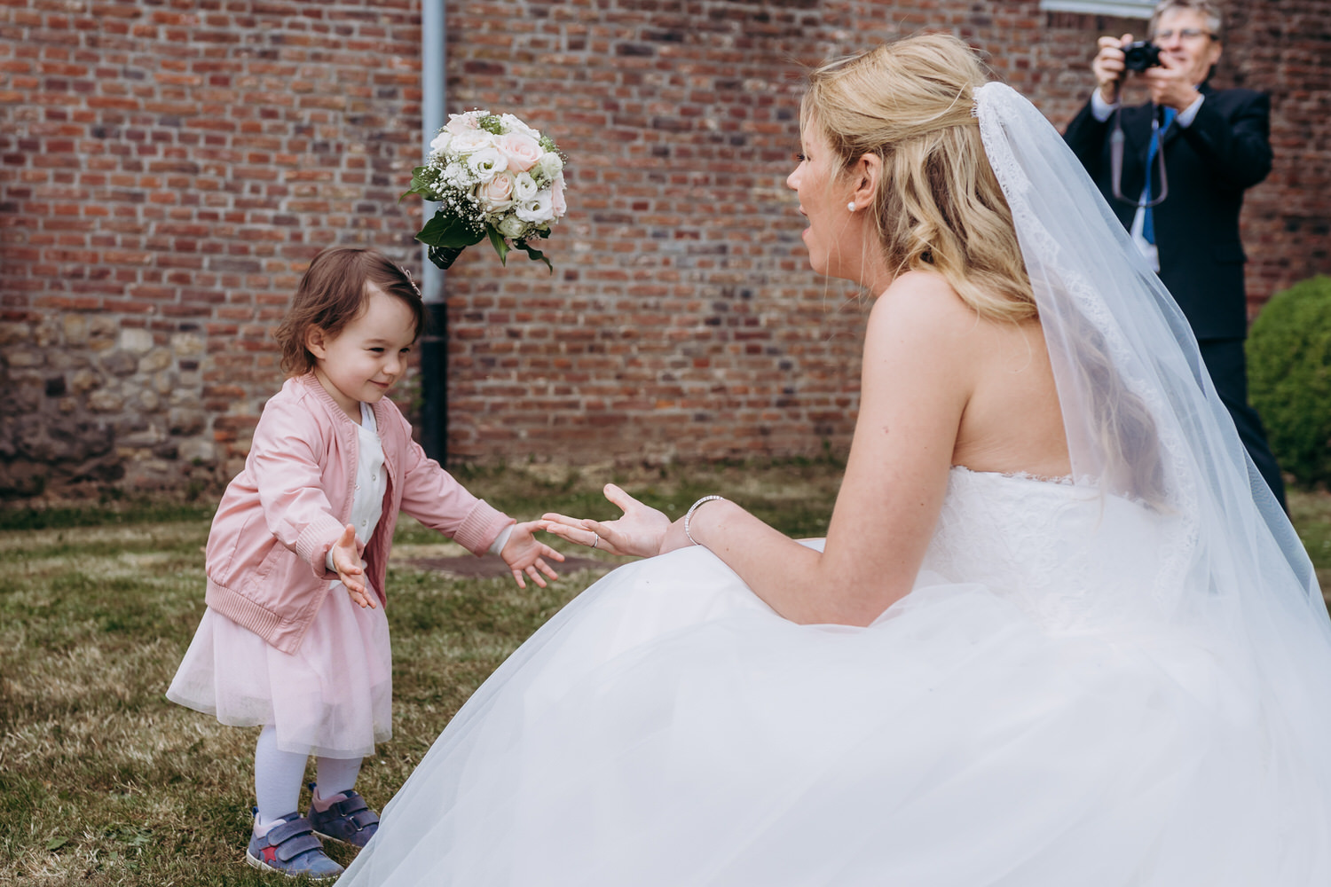 eine Braut im Spiel mit einem kleinem Mädchen